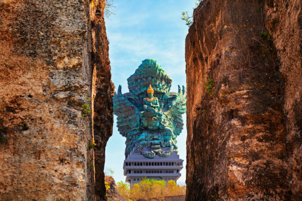 Landscape picture of old Garuda Wisnu Kencana GWK statue as  Bali landmark with blue sky as a background. Balinese traditional symbol of hindu religion. Popular travel destinations in Indonesia.