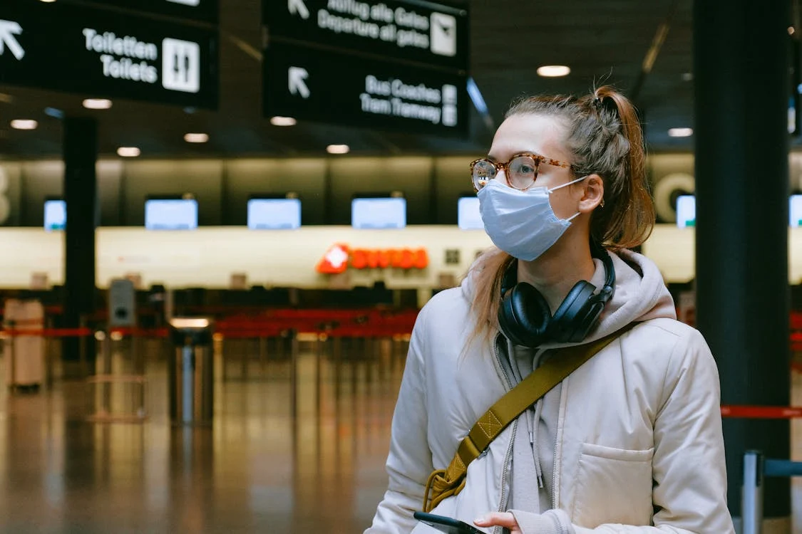 A woman wearing mask in an airport.